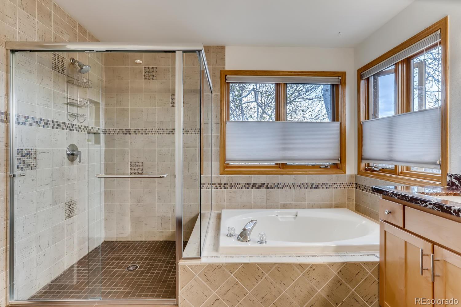 1450 Oakleaf Circle Boulder, CO 80304 - Photo 15 of 27 a bathroom with a tub a window and a shower