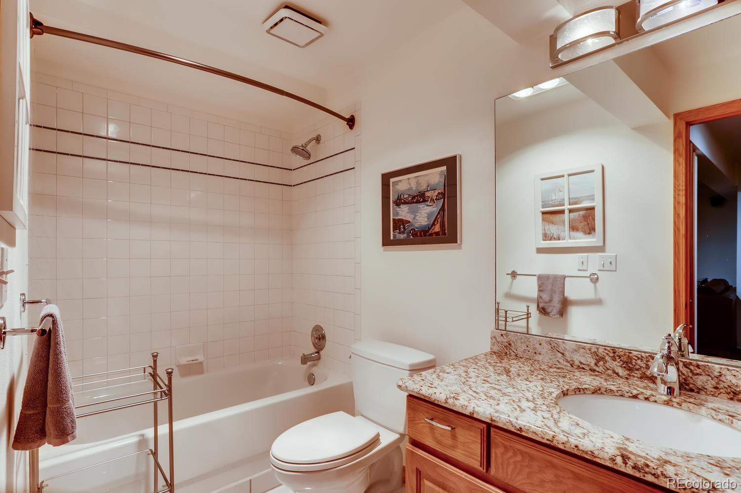 1450 Oakleaf Circle Boulder, CO 80304 - Photo 17 of 27 a bathroom with a granite countertop sink toilet and shower