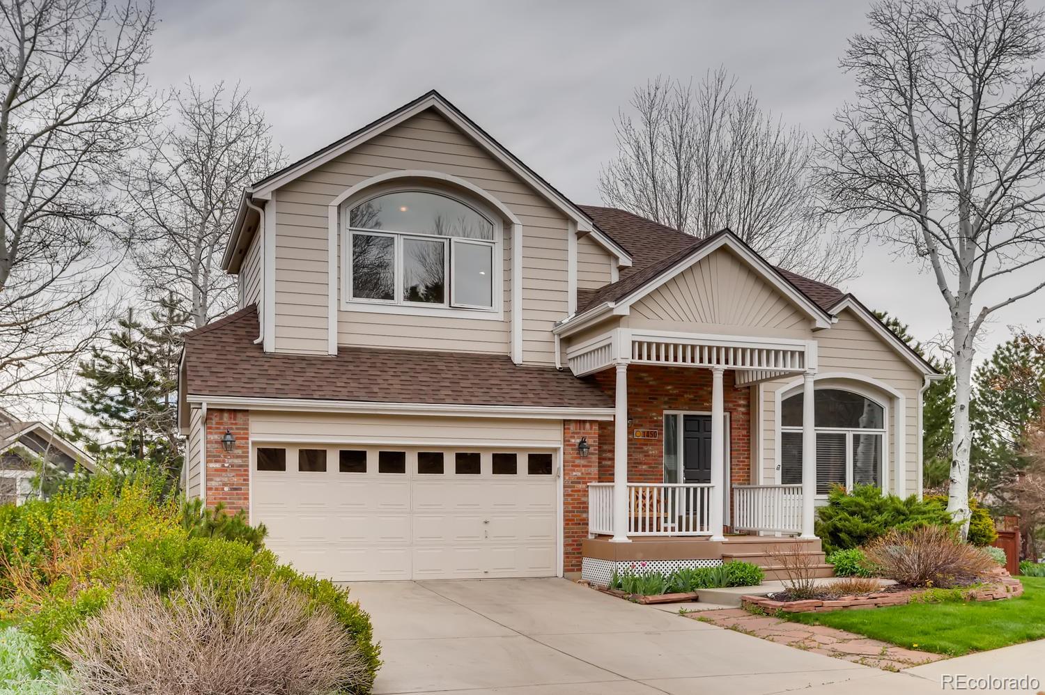 1450 Oakleaf Circle Boulder, CO 80304 - Photo 2 of 27 a front view of a house with a yard and garage