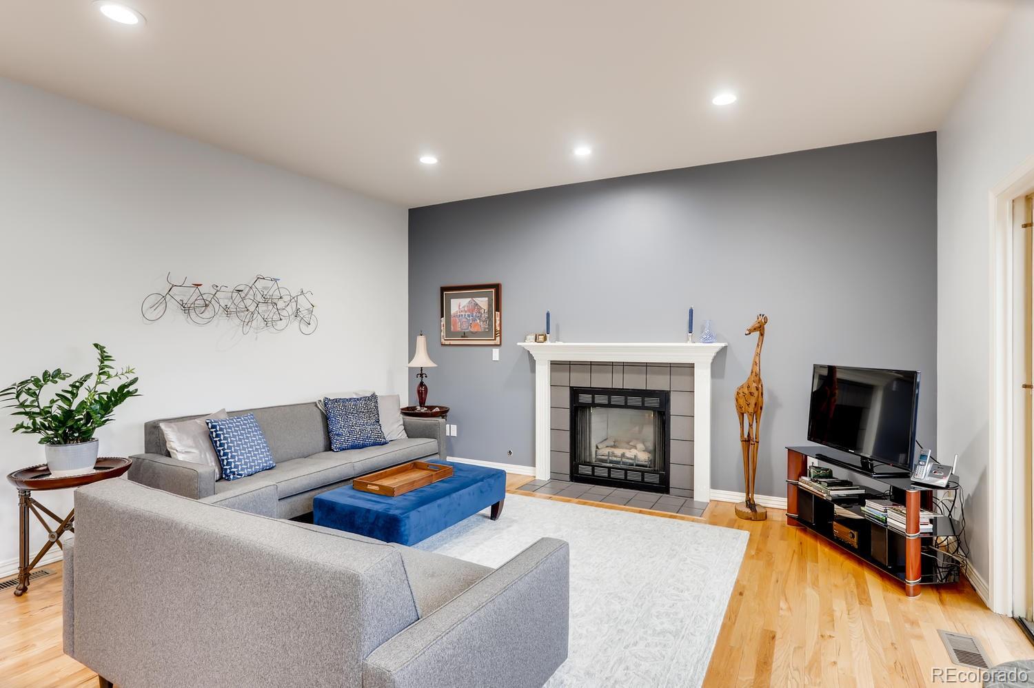 1450 Oakleaf Circle Boulder, CO 80304 - Photo 21 of 27 a living room with furniture a flat screen tv and a fireplace