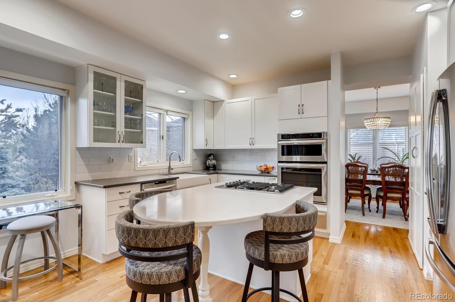 1450 Oakleaf Circle Boulder, CO 80304 - Photo 8 of 27 a kitchen with granite countertop a table chairs stove and cabinets