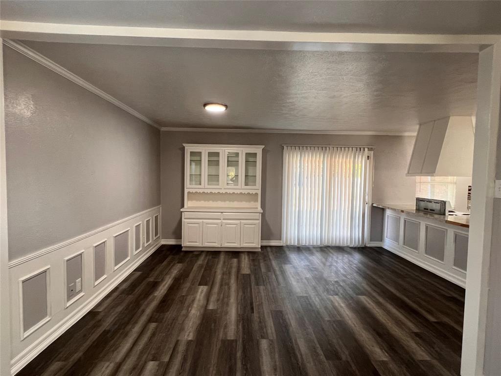 8506 Woodside Road Rowlett, TX 75088 - Photo 22 of 25 a big room with wooden floor a sink and windows