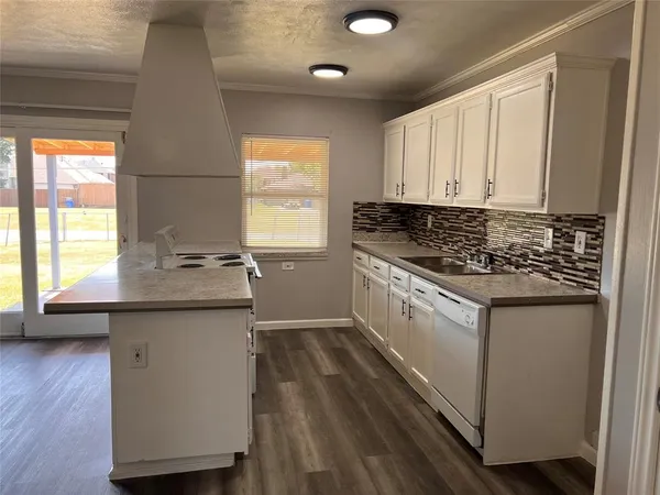 a kitchen with granite countertop white cabinets and white appliances