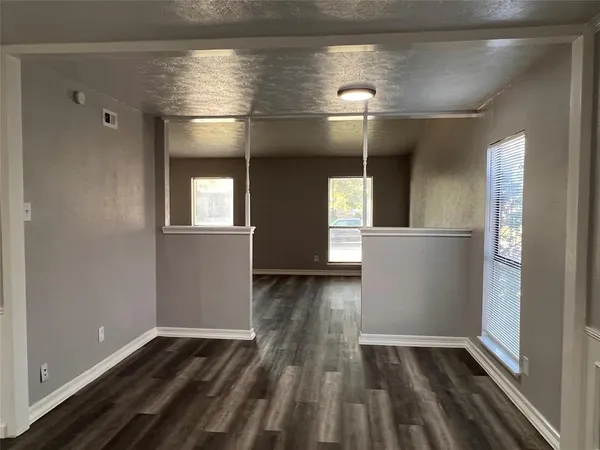 a view of a livingroom with wooden floor and a window