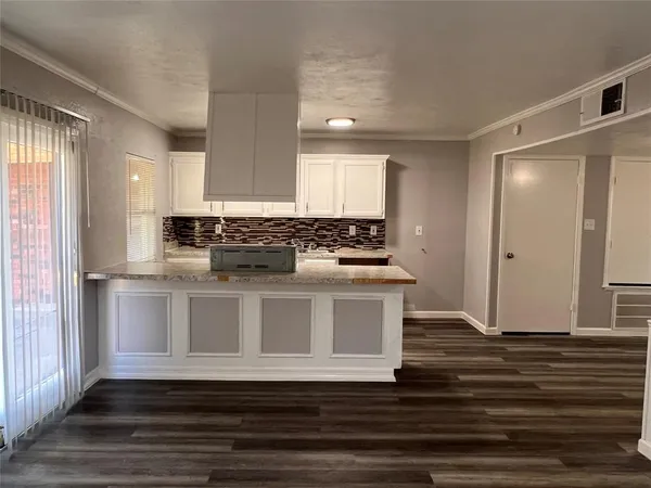 a view of kitchen with granite countertop window and stainless steel appliances