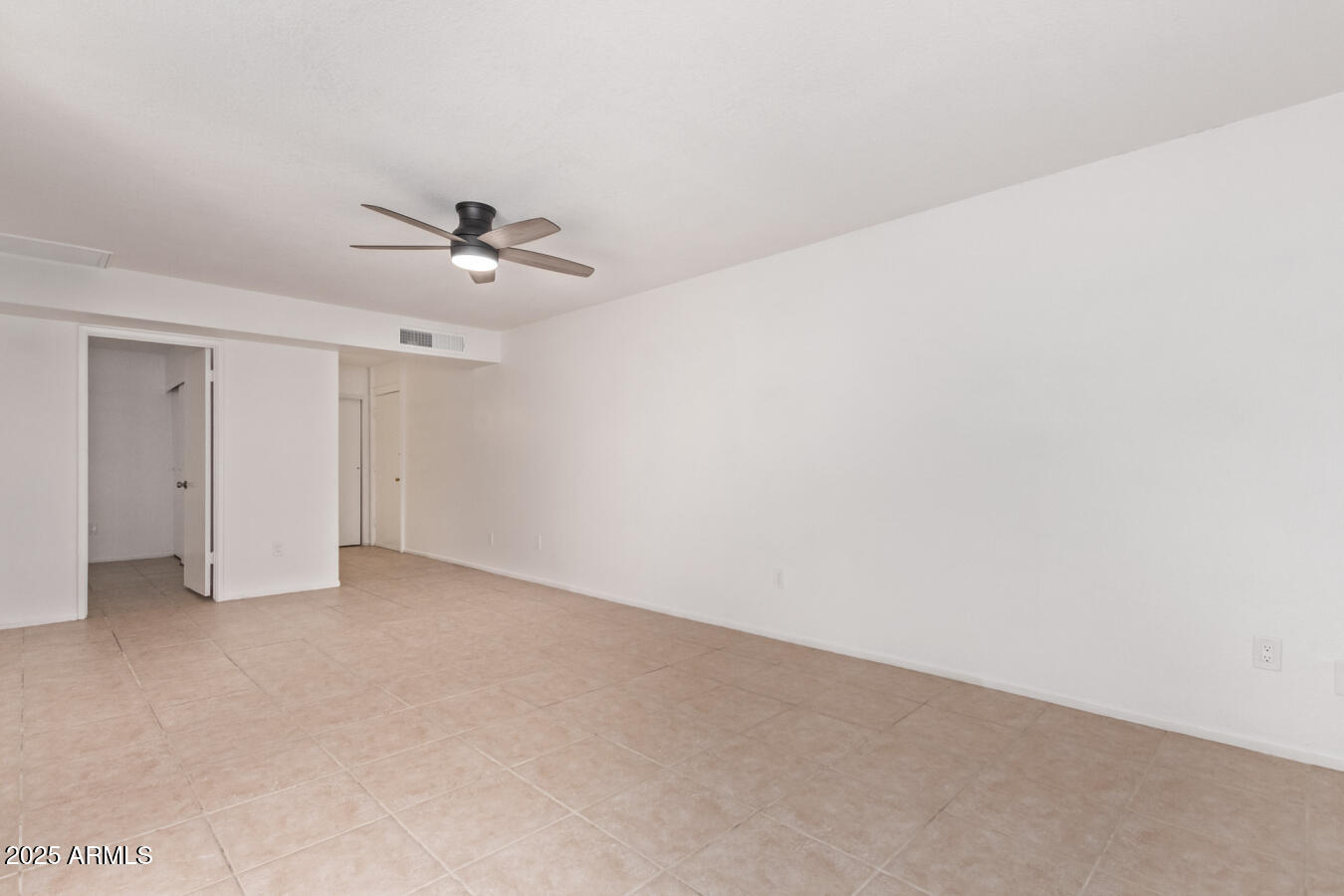 1701 West Tuckey Lane, Unit 231 Phoenix, AZ 85015 - Photo 7 of 17 a view of an empty room with a ceiling fan
