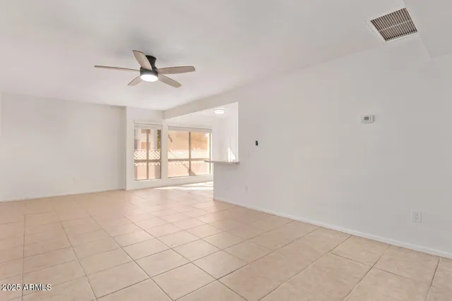 a view of a kitchen with furniture and a ceiling fan