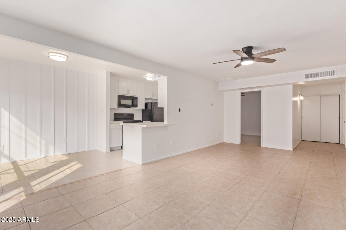 1701 West Tuckey Lane, Unit 231 Phoenix, AZ 85015 - Photo 10 of 17 a view of a kitchen with furniture and a ceiling fan