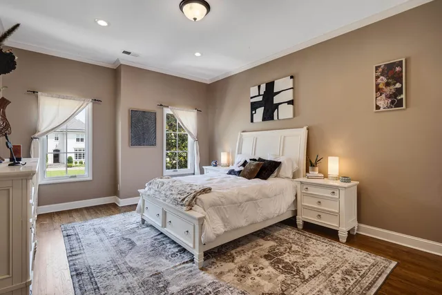 a bedroom with a large bed and a window