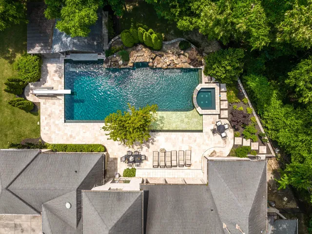an aerial view of a house with a garden and swimming pool