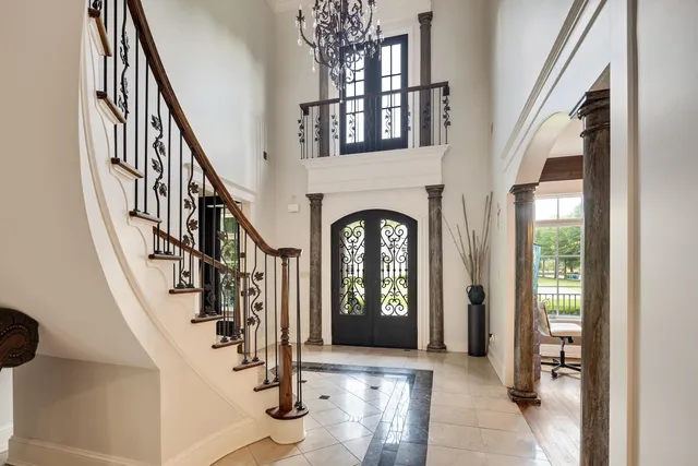 a view of an entryway with wooden floor windows and a livingroom