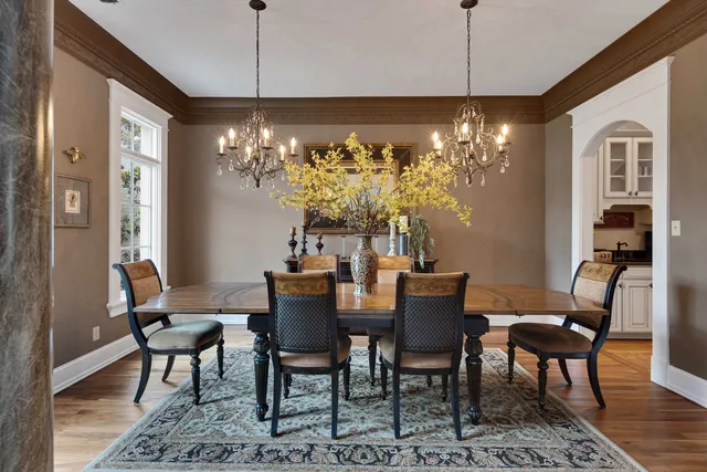 a view of a dining room with furniture wooden floor and chandelier