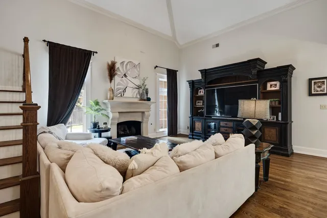 a living room with furniture a fireplace and a flat screen tv