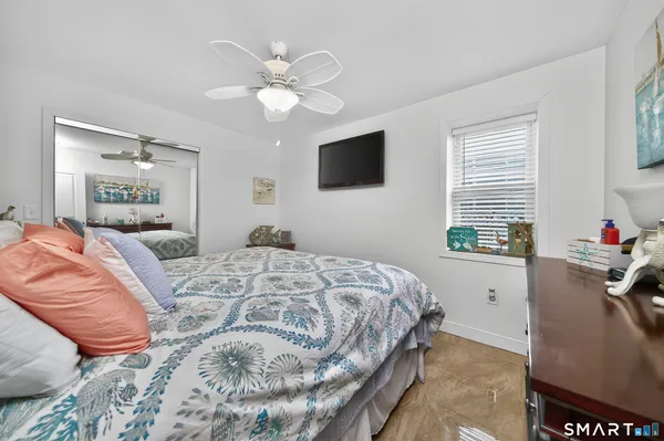 a bed sitting in a bedroom next to a window