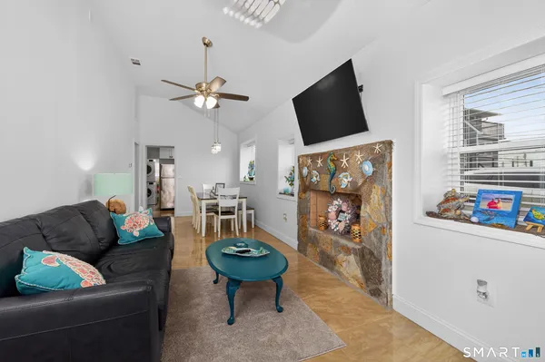 a living room with furniture a rug and a chandelier