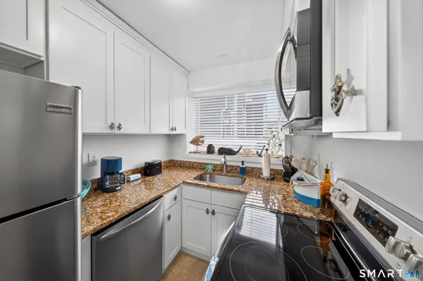 a kitchen with a sink stove top oven and cabinets