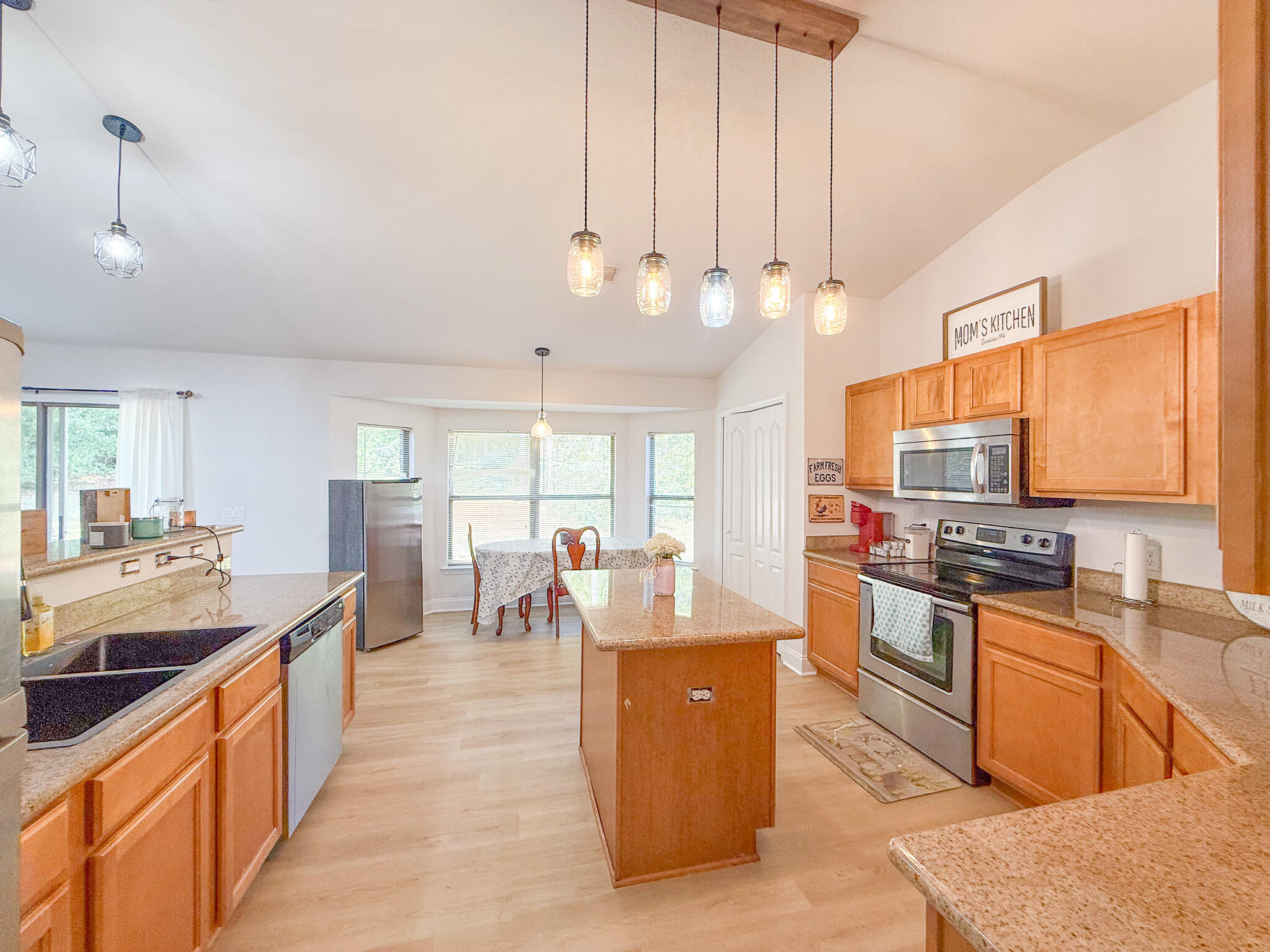 6214 Flash Lane Crestview, FL 32536 - Photo 14 of 42 a large kitchen with kitchen island a large counter top space a sink stainless steel appliances and cabinets