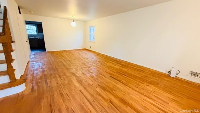143-15 22nd Road Queens, NY 11357 - Photo 3 of 16 a view of empty room with wooden floor and fan