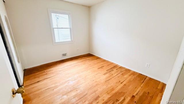 143-15 22nd Road Queens, NY 11357 - Photo 6 of 16 an empty room with windows