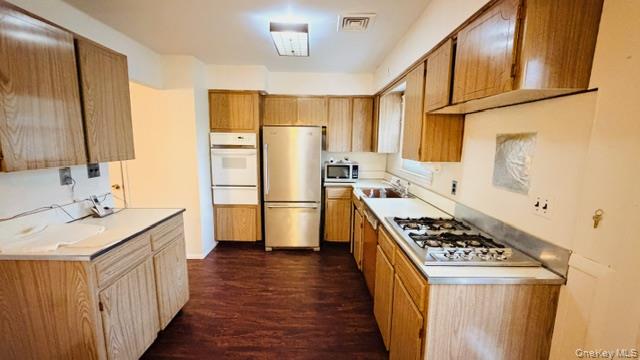 143-15 22nd Road Queens, NY 11357 - Photo 9 of 16 a kitchen with stainless steel appliances a refrigerator a sink and wooden floors