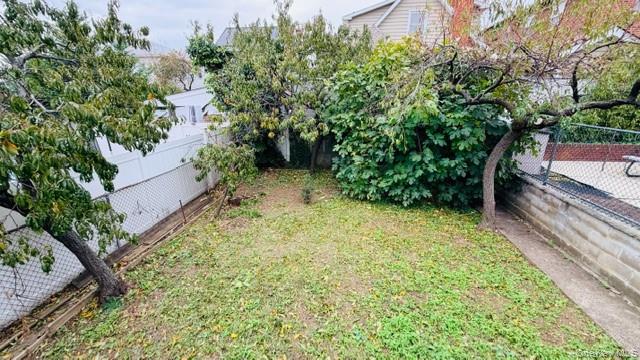 143-15 22nd Road Queens, NY 11357 - Photo 10 of 16 a backyard of a house with lots of green space