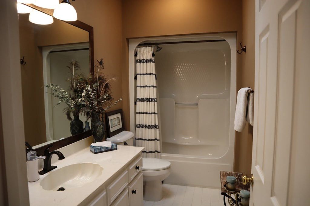 7208 West Wynfield Loop Midland, GA 31820 - Photo 11 of 20 a bathroom with a granite countertop sink toilet and shower