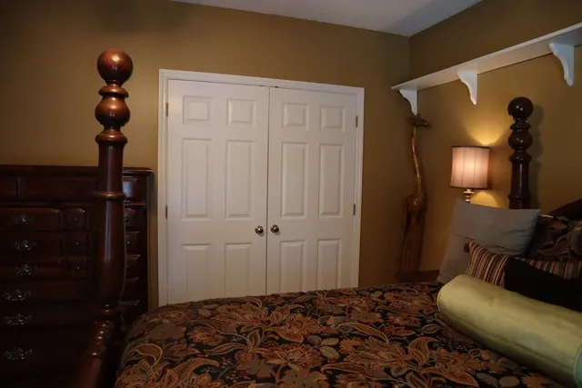 a bedroom with a bed and cabinets