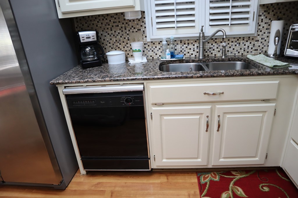 7208 West Wynfield Loop Midland, GA 31820 - Photo 7 of 20 a kitchen with granite countertop a sink and a white stove