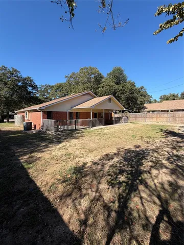 a view of house with outdoor space and swimming pool