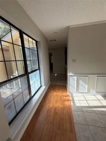 a view of hallway with wooden floor