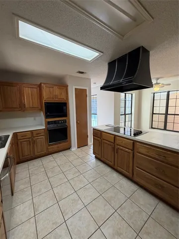 a kitchen with stainless steel appliances wooden cabinets and a sink