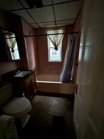 a bathroom with a toilet a sink and bathtub