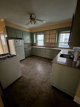 a kitchen with refrigerator and window