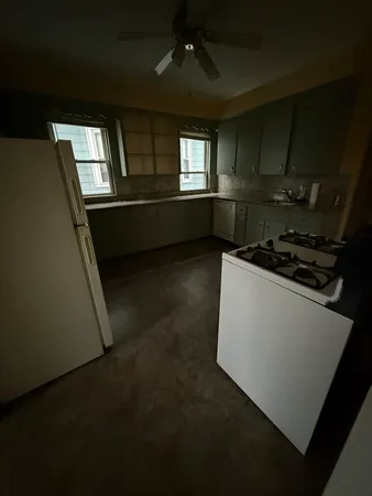a kitchen with granite countertop a stove and a refrigerator