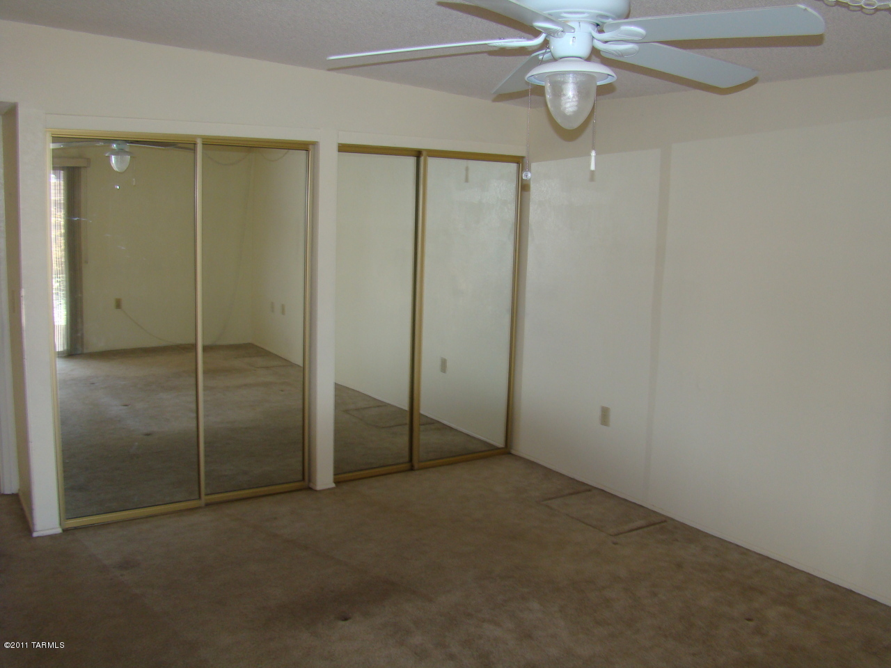 1443 North Rio-Aros Green Valley, AZ 85614 - Photo 10 of 19 a view of an empty room with fan and window