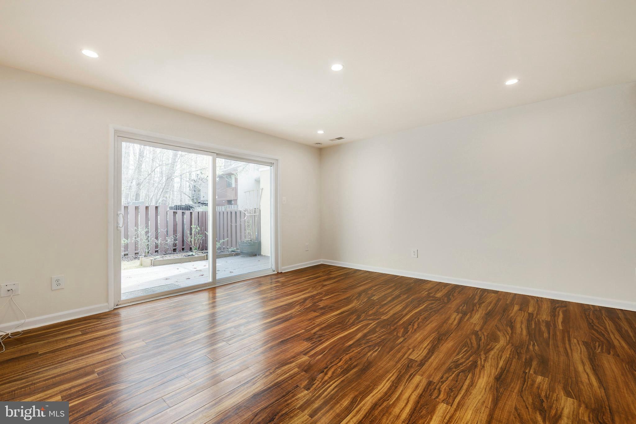 2179 White Cornus Lane Reston, VA 20191 - Photo 5 of 27 a view of an empty room with wooden floor and a window