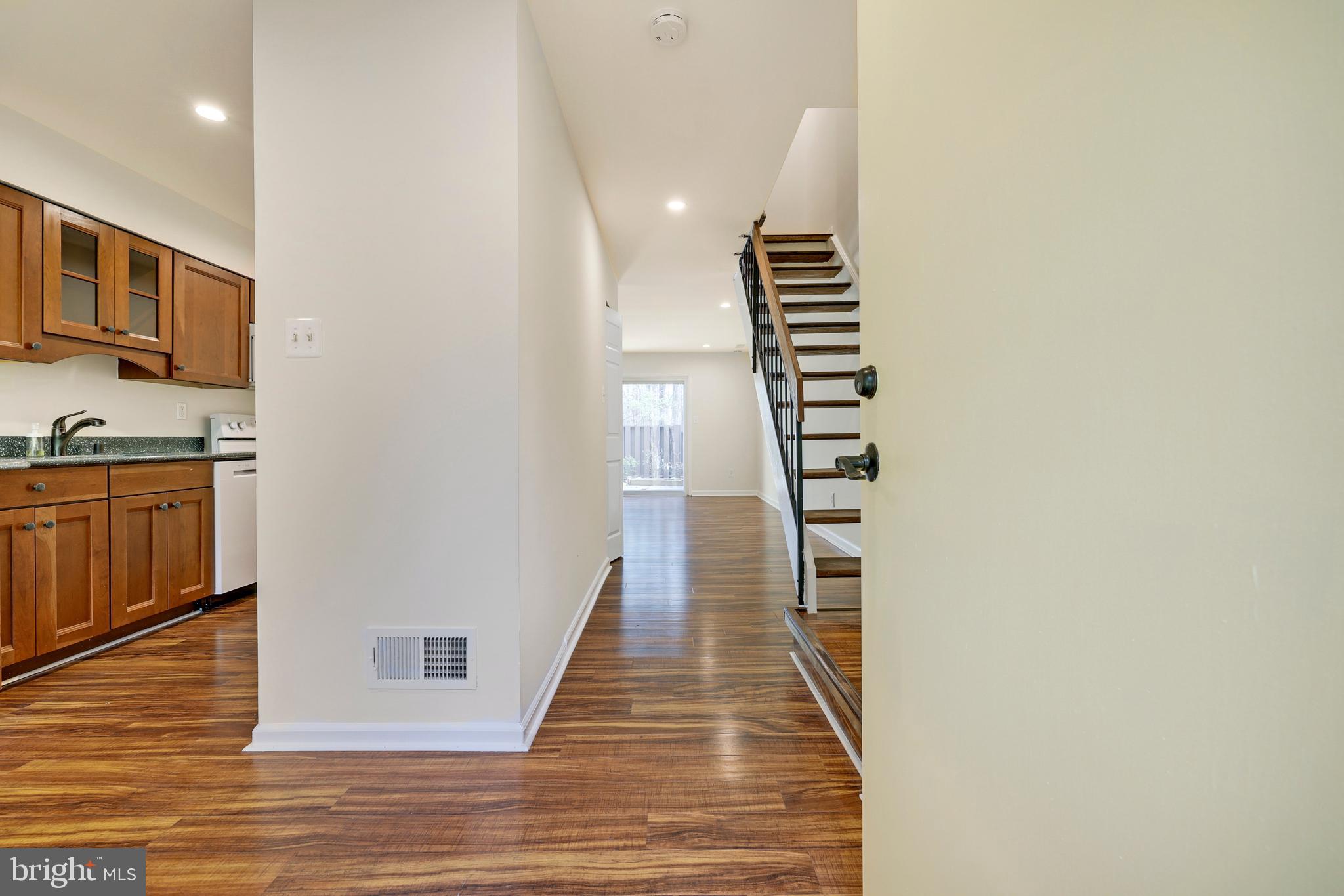 2179 White Cornus Lane Reston, VA 20191 - Photo 9 of 27 a view of hallway with stairs and wooden floor