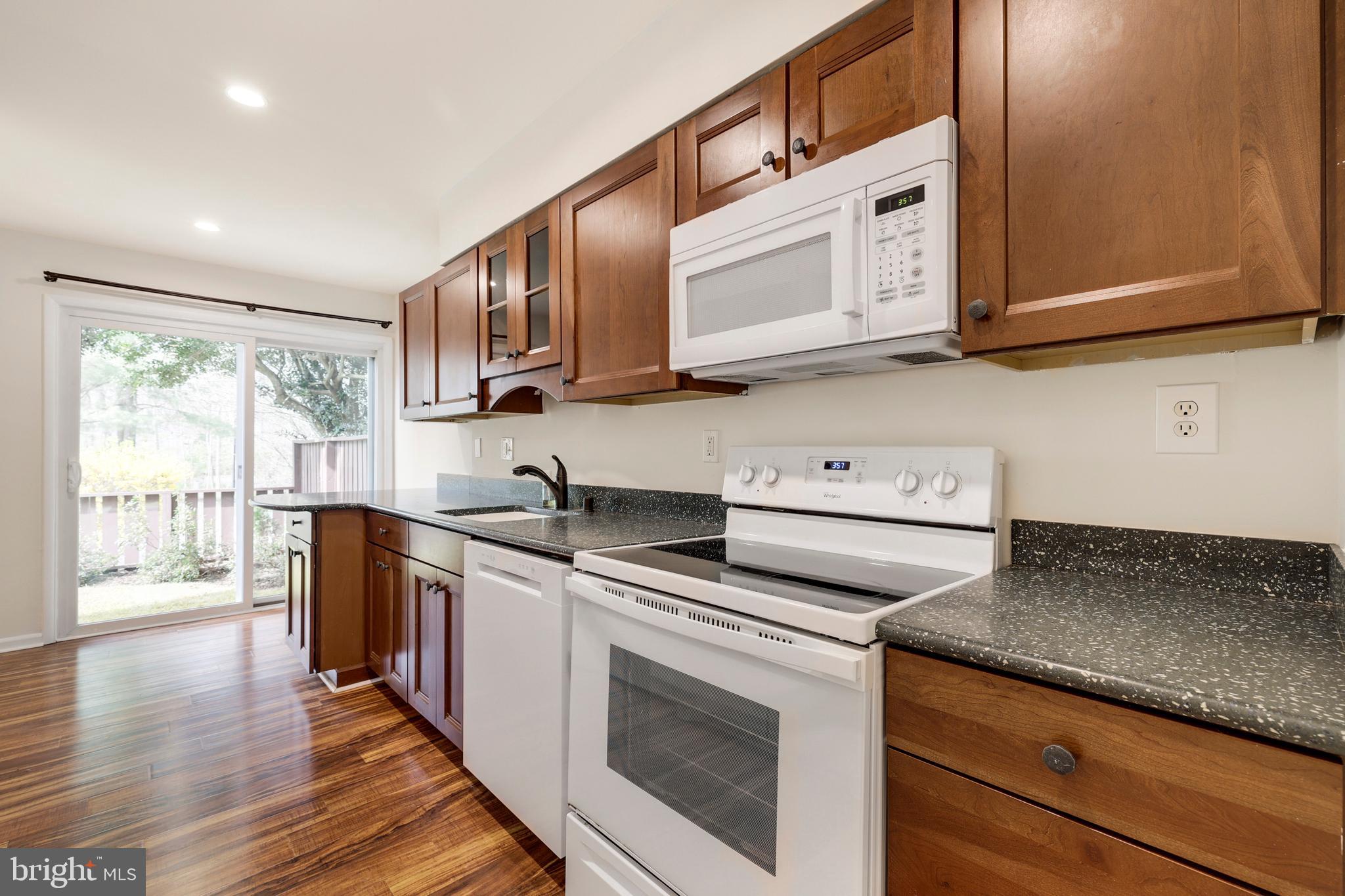 2179 White Cornus Lane Reston, VA 20191 - Photo 10 of 27 a kitchen with stainless steel appliances granite countertop a stove a sink and a microwave