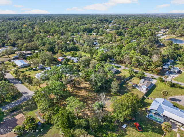 a view of a city with lush green forest