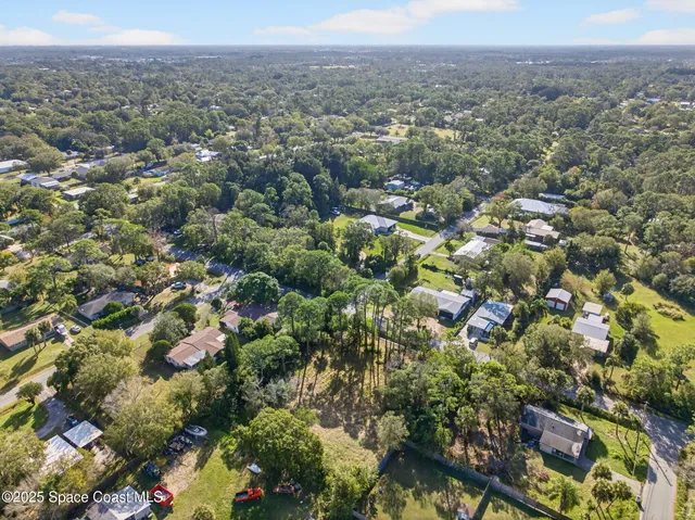 an aerial view of town with residential houses and green space