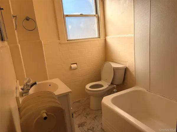 a bathroom with a toilet and a tub