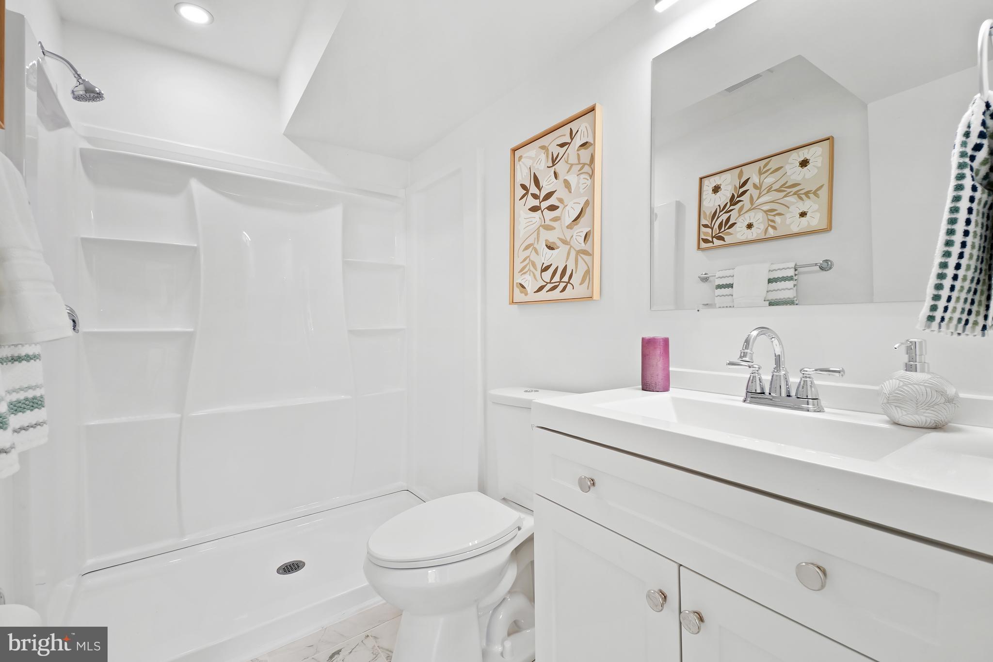 3731 Falls Road Baltimore, MD 21211 - Photo 24 of 30 a bathroom with a sink a toilet and a shower