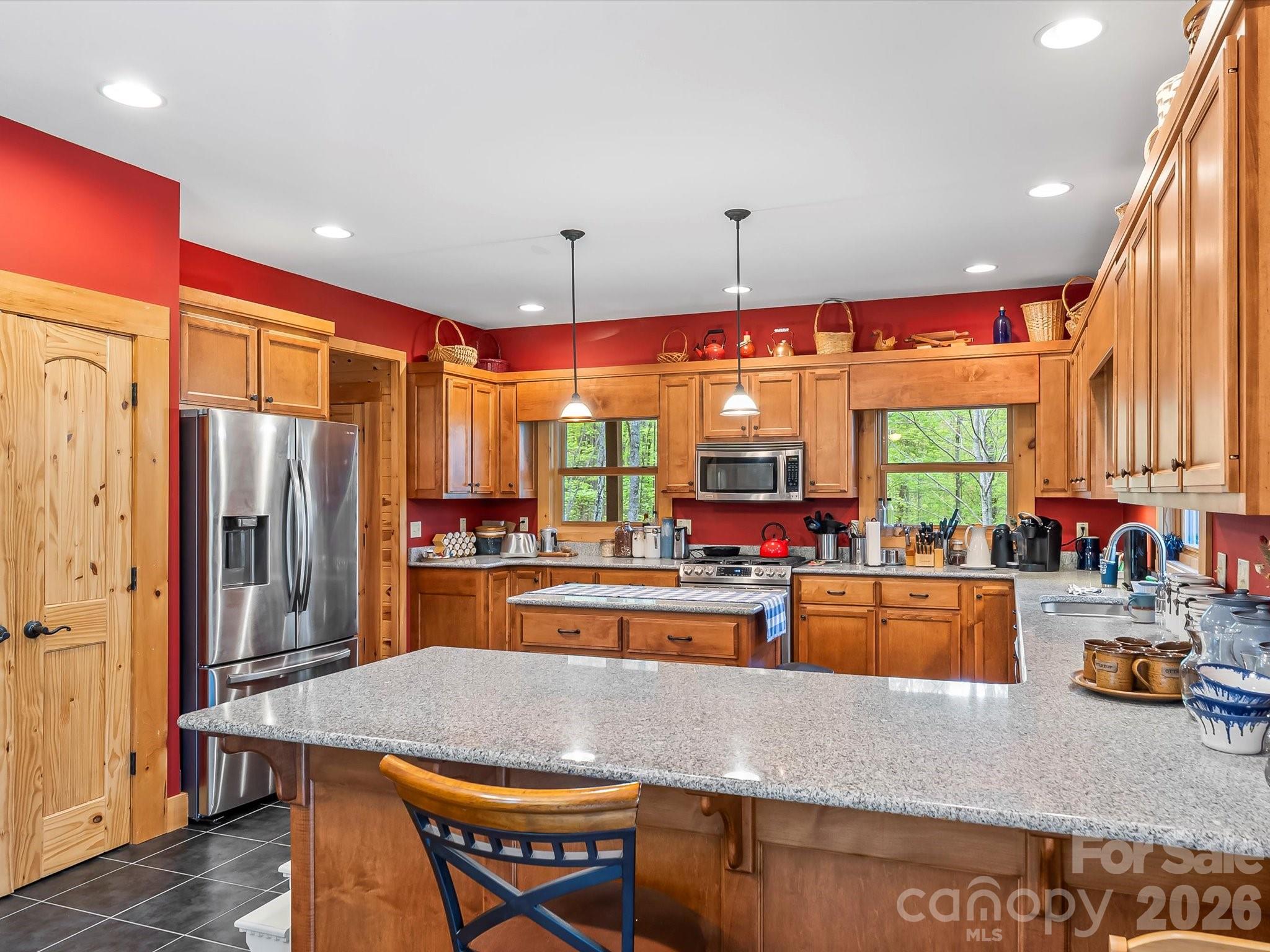 917 Otter Mountain Road Topton, NC 28781 - Photo 14 of 48 a kitchen with stainless steel appliances granite countertop a kitchen island a large window and cabinets