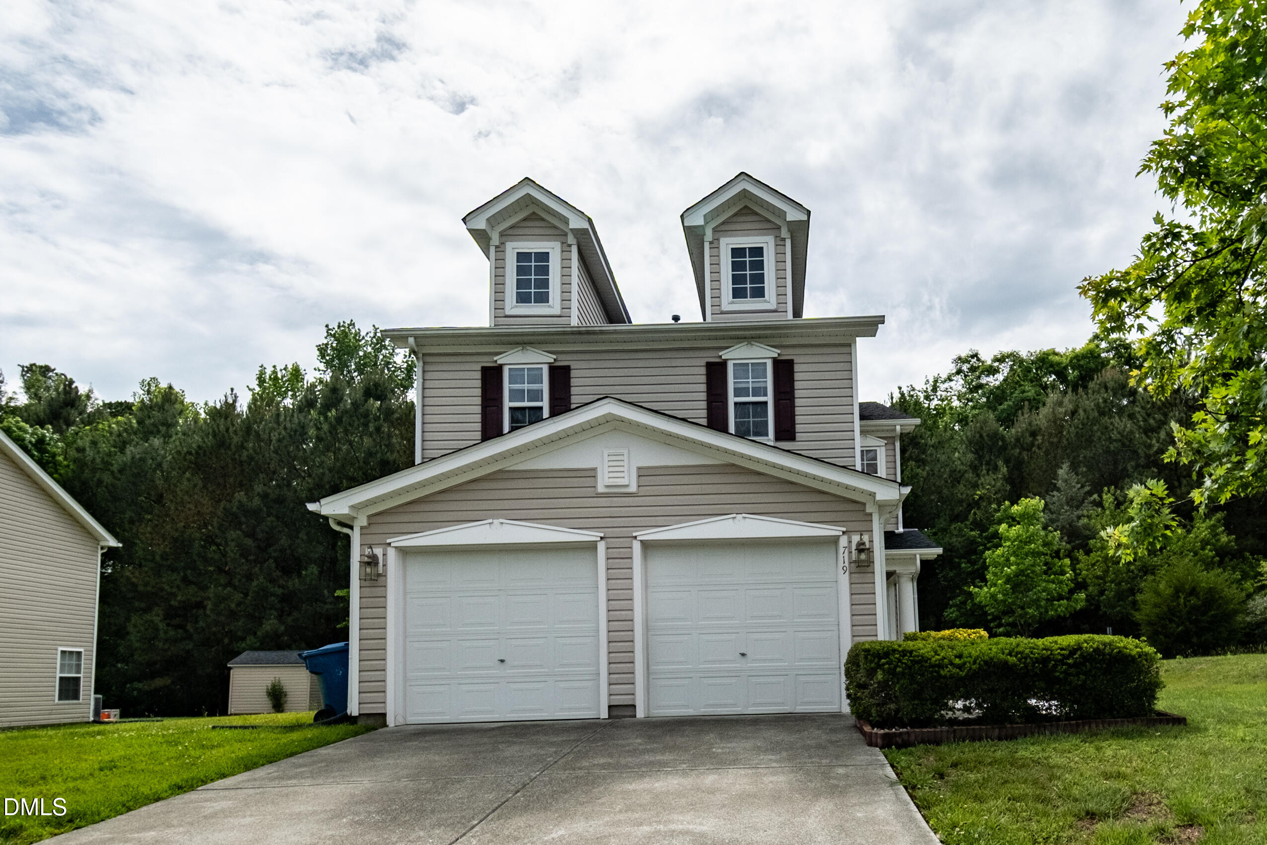719 Obsidian Way Durham, NC 27703 - Photo 1 of 41 a front view of a house with a yard and garage