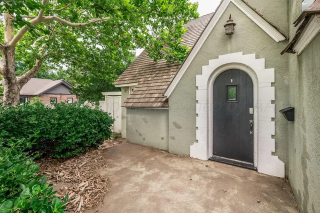 a view of a house with a porch and a garage