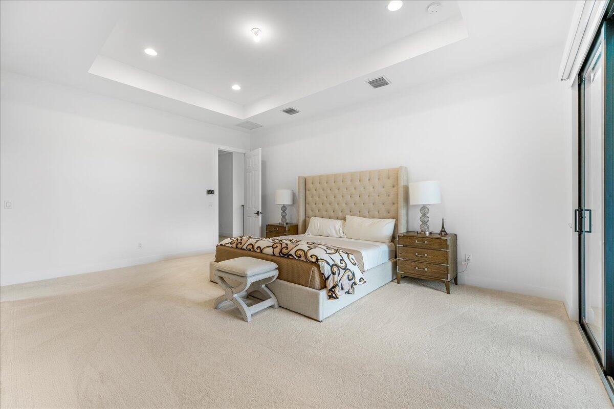 9093 Chauvet Way Boca Raton, FL 33496 - Photo 11 of 31 a bedroom with a bed and a chair