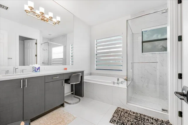 a bathroom with a double vanity sink a toilet and shower