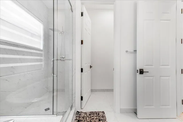 a bathroom with a glass shower door