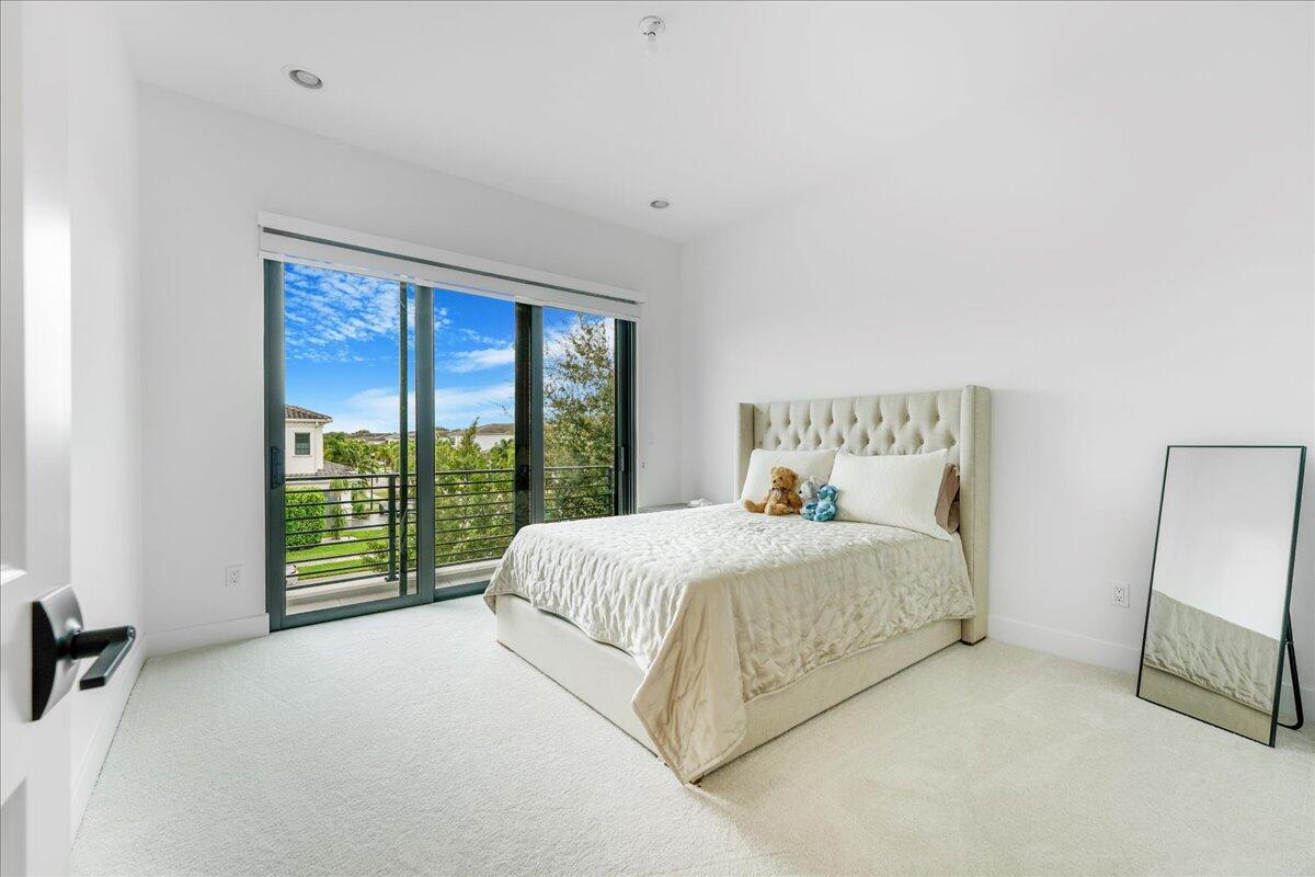 9093 Chauvet Way Boca Raton, FL 33496 - Photo 14 of 31 a bed sitting in a bedroom next to a window