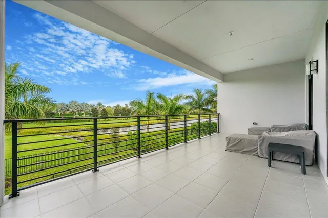 a view of a porch with furniture and garden